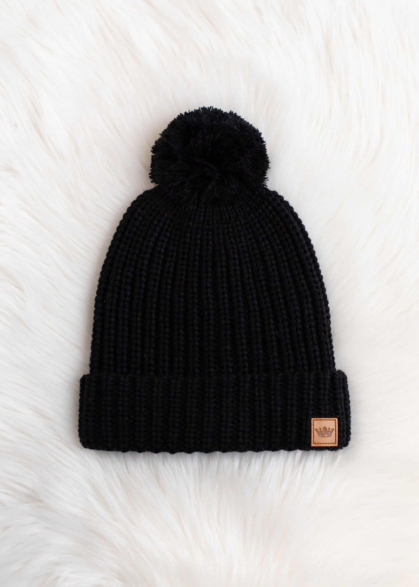 Adorable black slouchy knit beanie with matching pom accent